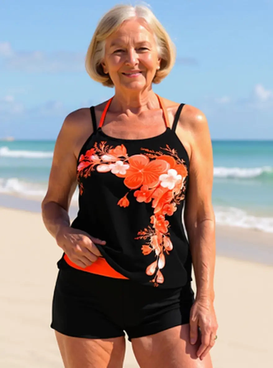 Vibrant floral halter tankini top & matching mid-rise swim bottom. Women's cross-strap swimwear set.