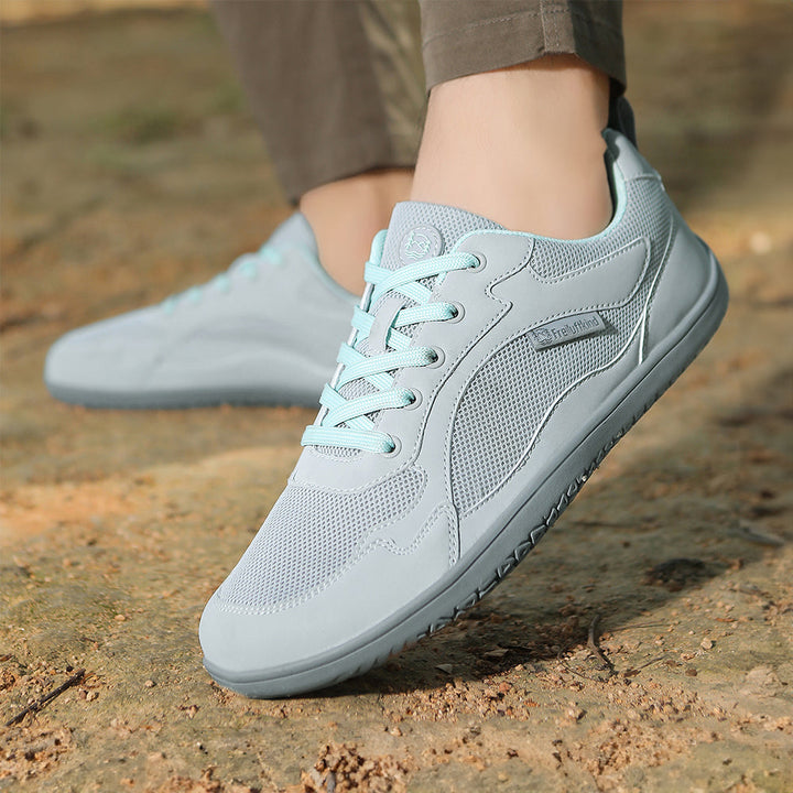 Sporty women's barefoot sneakers, water-resistant upper and flexible sole for outdoor readiness.