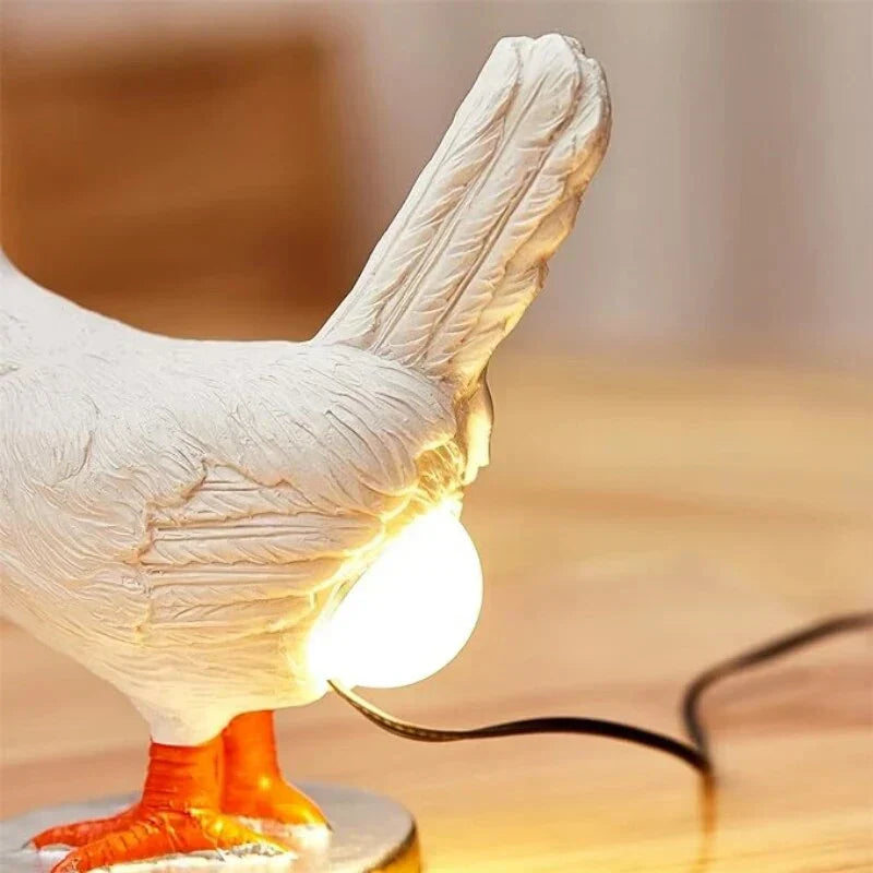 Funny chicken table lamp, a whimsical home decor accent. Unique animal LED novelty light for playful ambiance.