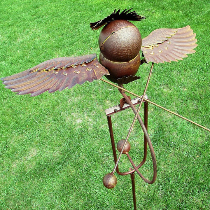 Artistic bird wind spinner, outdoor metal garden decor sculpture. Beautiful patio & yard art.