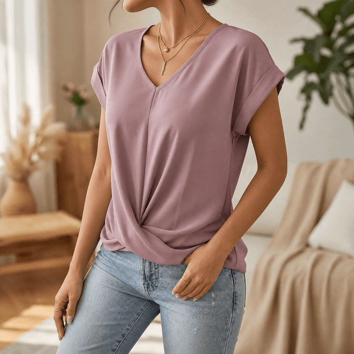 Women's stylish everyday top: V-neck, cap sleeves, and a unique twist front detail. Comfortable.