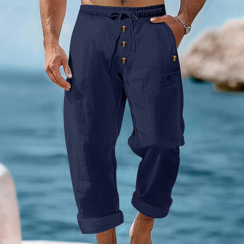 Man modeling effortless drawstring linen cargo pants, showcasing summer style and relaxed fit comfort.