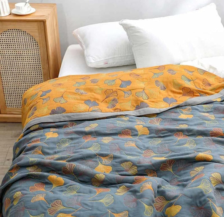 Stylish ginkgo leaf pattern throw blanket for cozy home decor. Elegant nature-inspired reversible design.