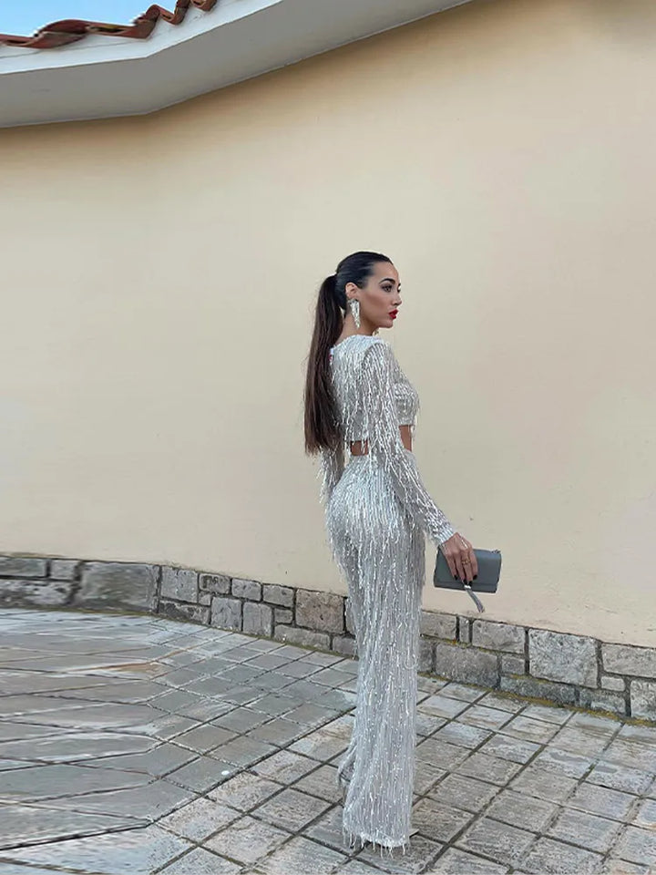 Close-up of the shimmering sequins on a glamorous women's two-piece party outfit.