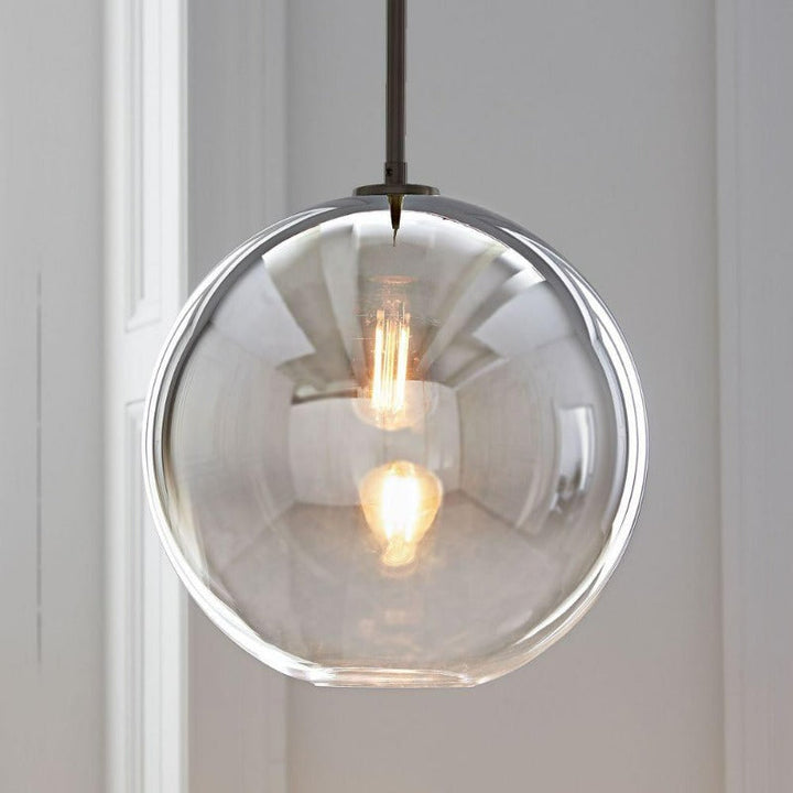Sleek spherical glass pendant light featuring a silver accent, perfect for contemporary design.