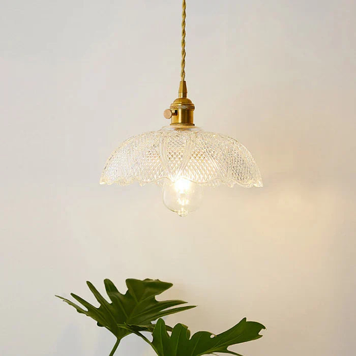 Industrial glass pendant lamp, stylish and functional for kitchen spaces.