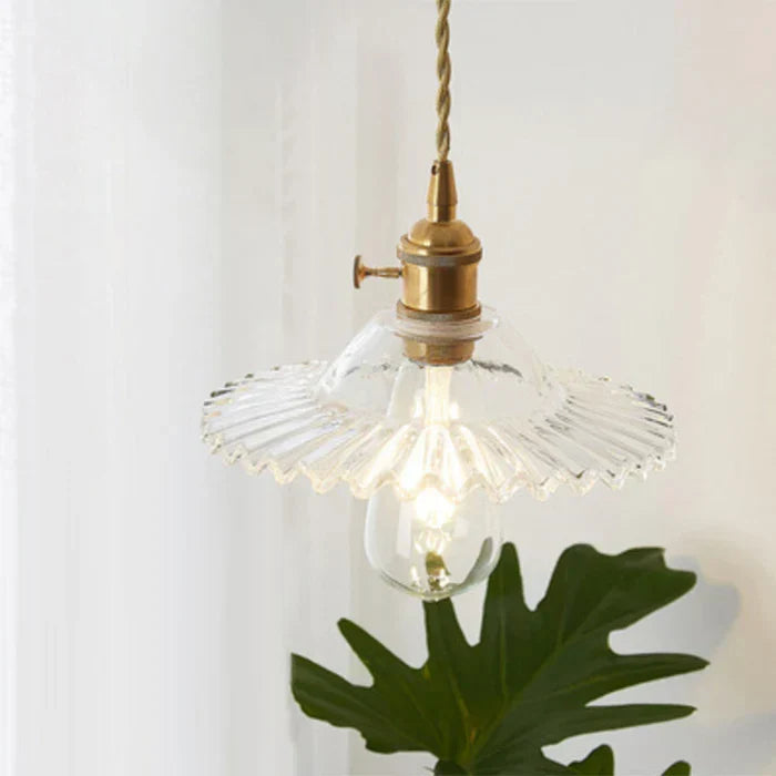 Modern industrial glass pendant light, suitable for kitchen island illumination.