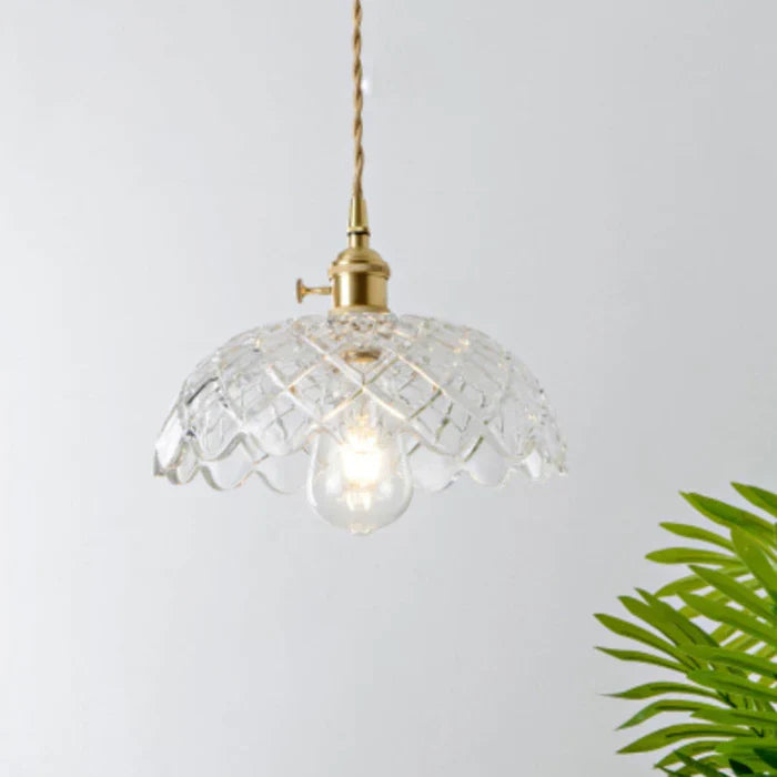 Transparent glass pendant lamp, adds sophisticated touch to home decor.