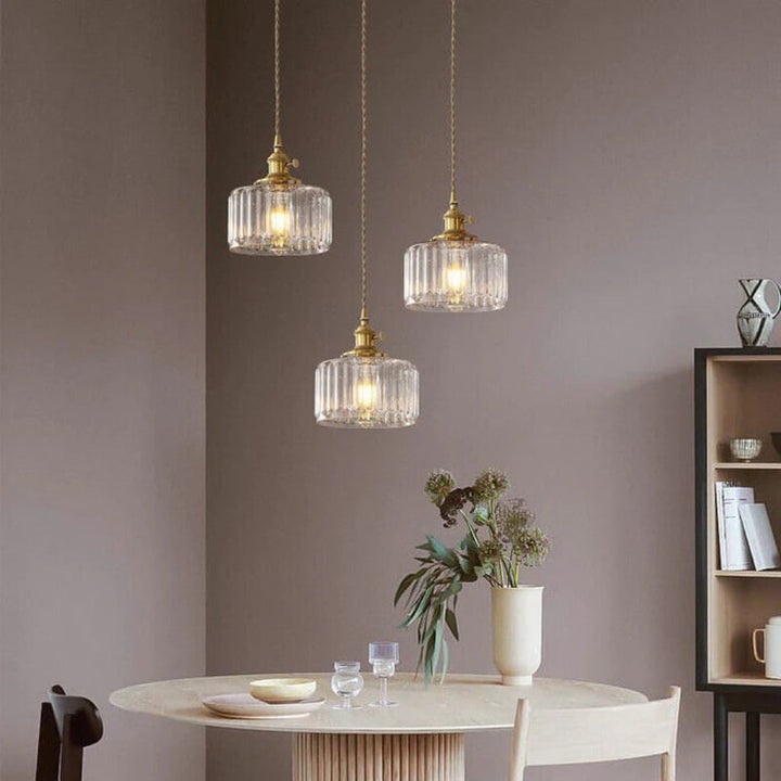 Adjustable green glass pendant light fixture for modern aesthetics.