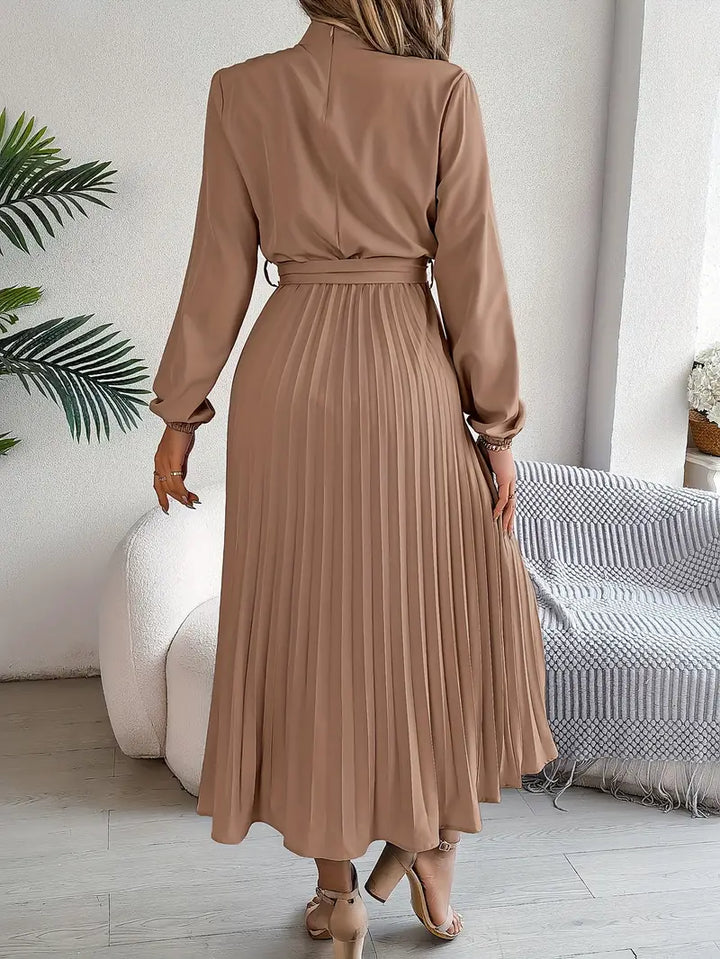 Elegant light blue pleated midi dress with a belt & long sleeves, ideal for formal or cocktail wear.