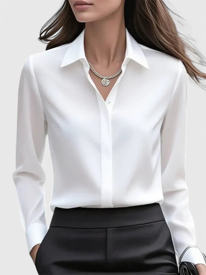 Tailored women's long-sleeve button-down blouse, neat concealed placket for a polished professional work look.