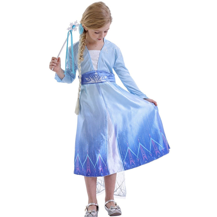 Girl in an elegant Ice Princess costume dress with a long cape, ready for a Halloween party.