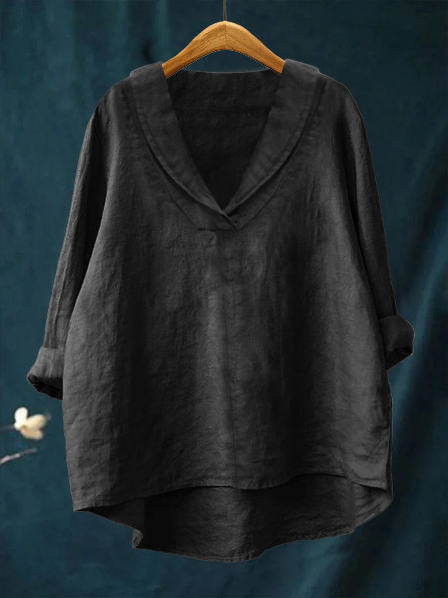 Close-up of a women's relaxed fit V-neck blouse, showcasing the fabric and long sleeve detail.