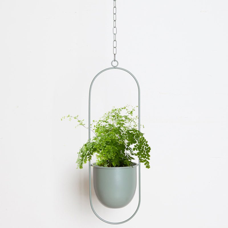 Artistic metal hanging planter for a sophisticated touch to your home or garden.