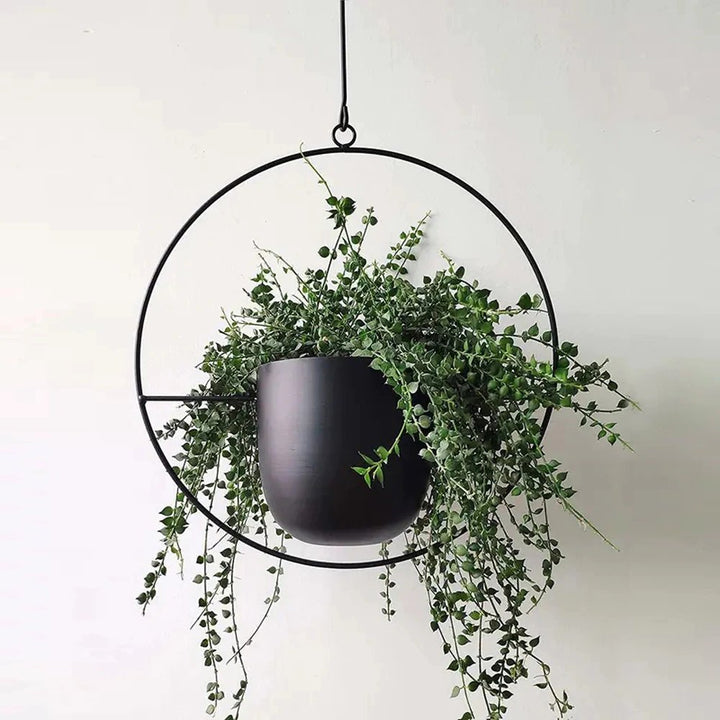 Stylish metal hanging planter, a chic garden accessory for home decor.