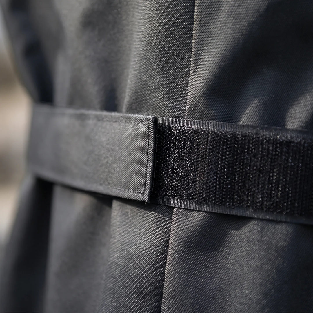 Protective black outdoor BBQ grill cover, heavy-duty and weather-resistant for gas grills, ensuring durability.
