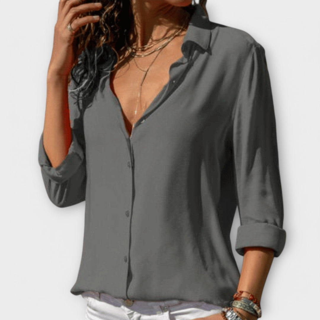 Stylish women's workwear blouse: polished, long-sleeve, collared, and button-down for an elegant look.