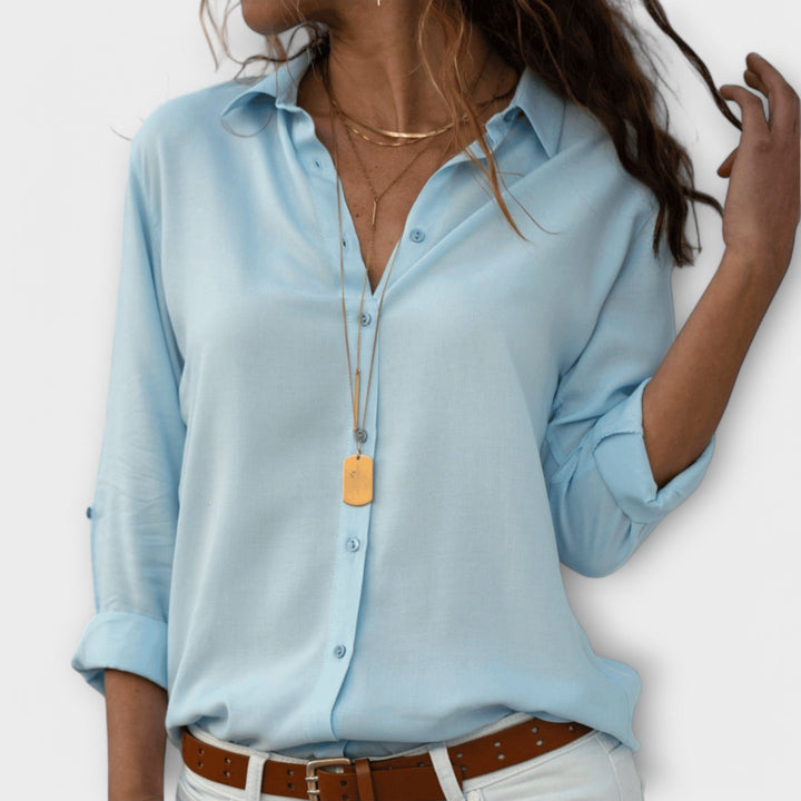 Sophisticated women's collared button-down blouse with long sleeves, perfect as a polished elegant work top.