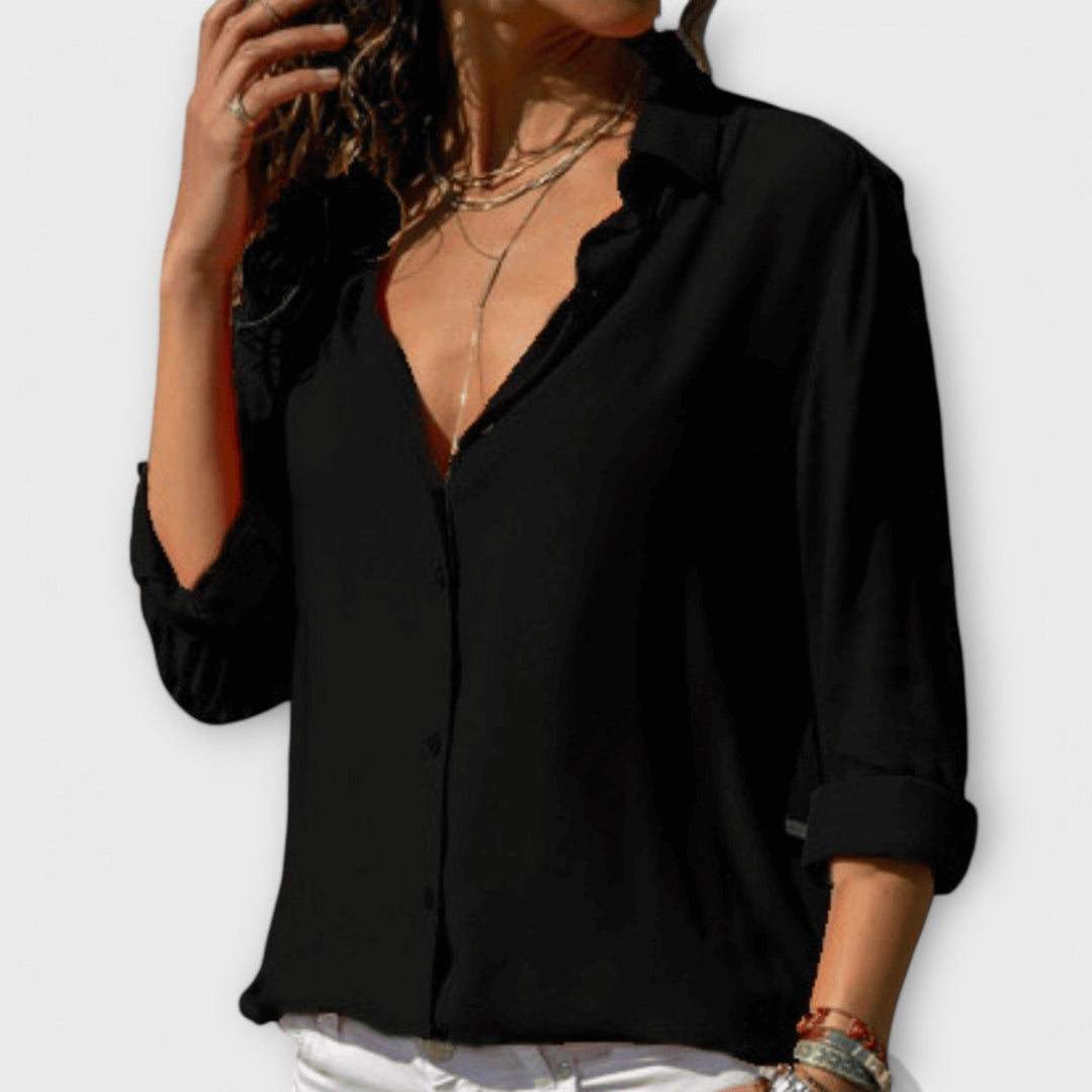 Classic women's polished long-sleeve collared button-down blouse, a versatile and elegant fashion staple.