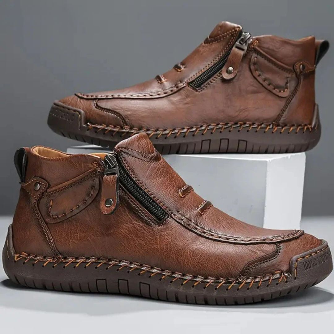 Men's orthopedic ankle boots with side zip and prominent stitched detail, offering comfort and support.