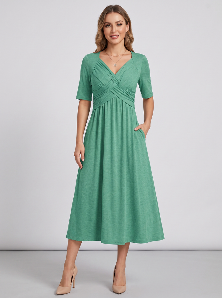 Women's V-neck wrap maxi dress laid flat, showcasing full A-line silhouette, short sleeves, & elegant design.