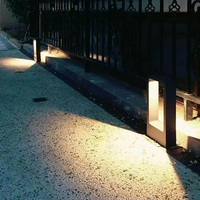 Sleek modern outdoor garden lamp, durable cast aluminum LED pathway light enhances exterior landscape & yard decor.