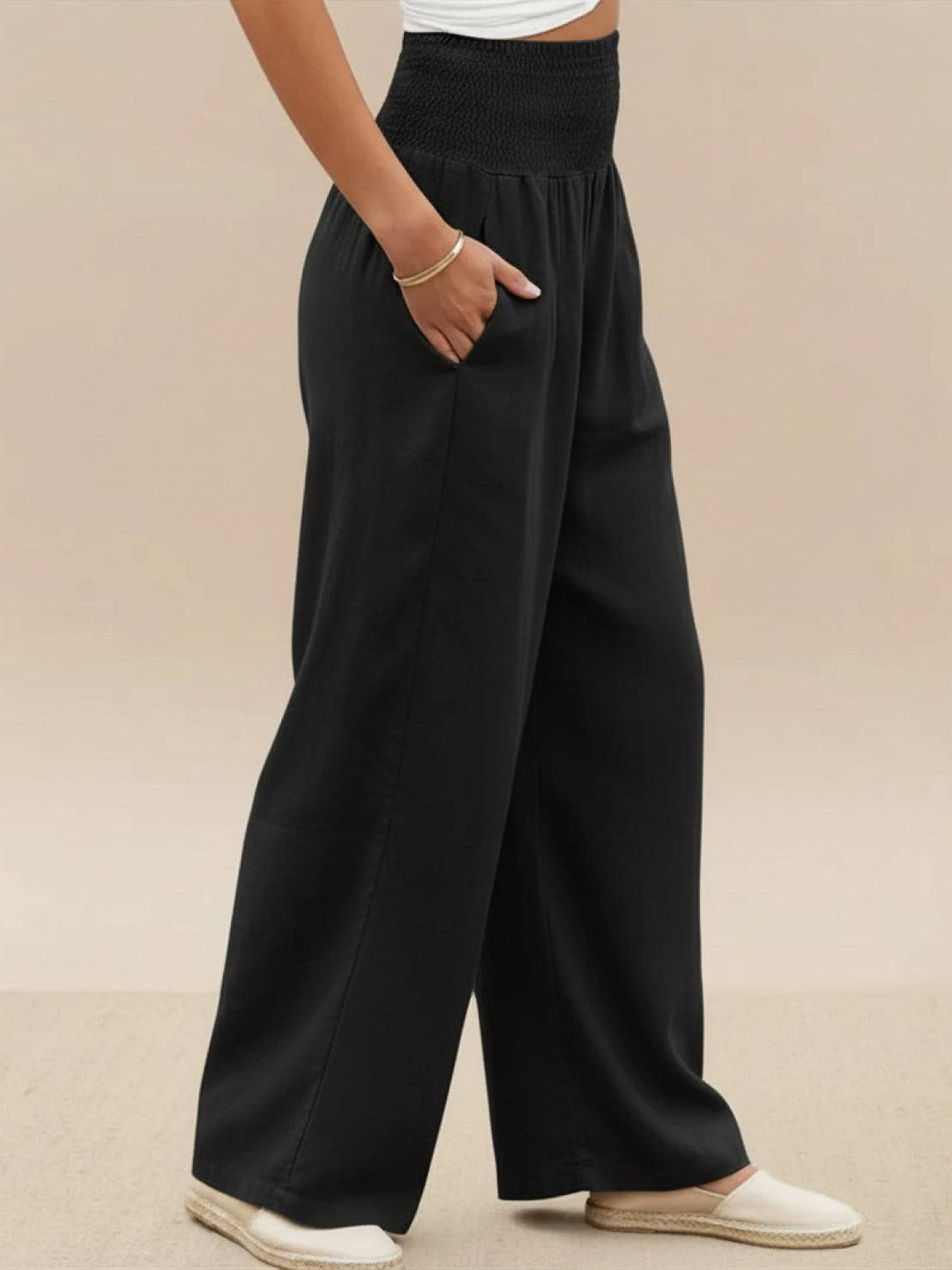 Women's high waist smocked wide leg palazzo pants, suitable for spring style.