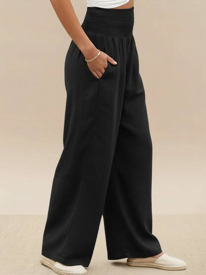 Women's high waist smocked wide leg palazzo pants, suitable for spring style.
