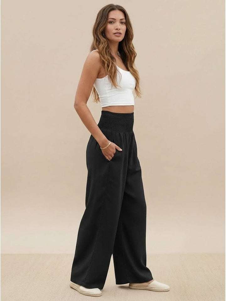 Chic navy women's high waist smocked wide leg palazzo pants, elegant & flowy.