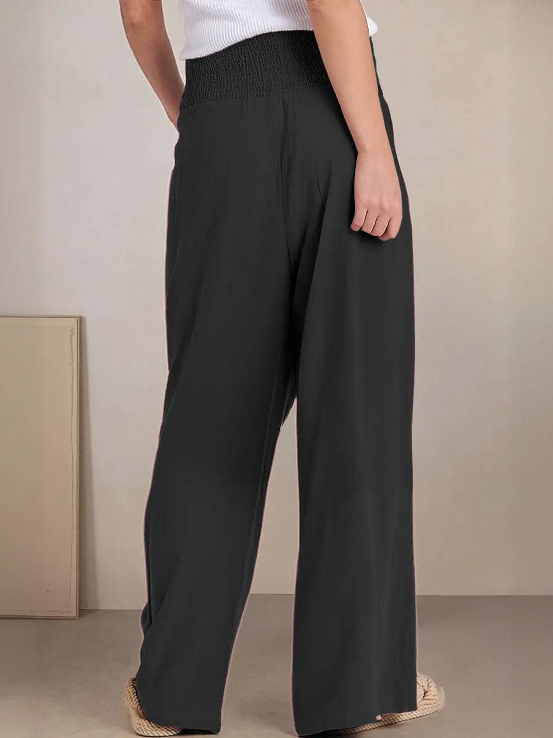 Relaxed fit women's smocked high waist wide leg palazzo pants, casual comfort.