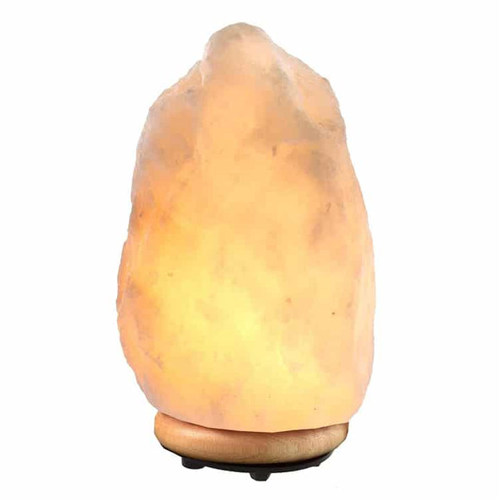 Rough-hewn natural Himalayan pink salt crystal lamp, casting a warm light. Ideal for meditation, relaxation & decor.