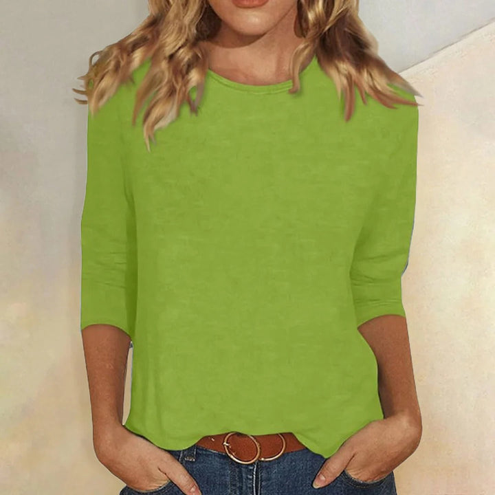 Model in a comfortable women's round neck 3/4 sleeve top, ideal for everyday and versatile fashion looks.