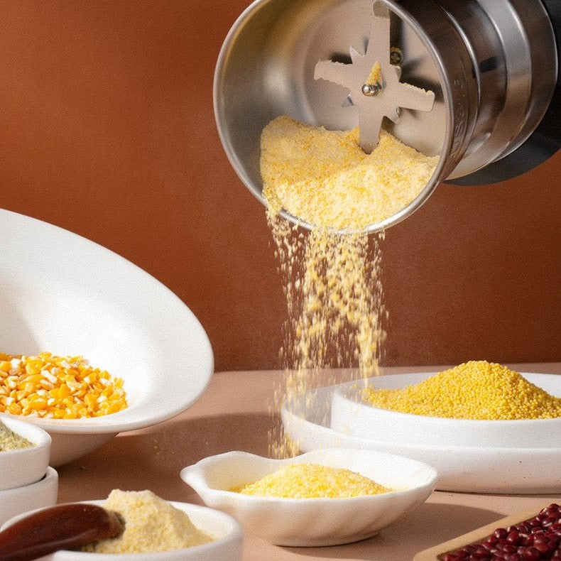 Sleek silver electric spice grinder for fresh herbs, whole coffee beans & food prep. Powerful kitchen tool.