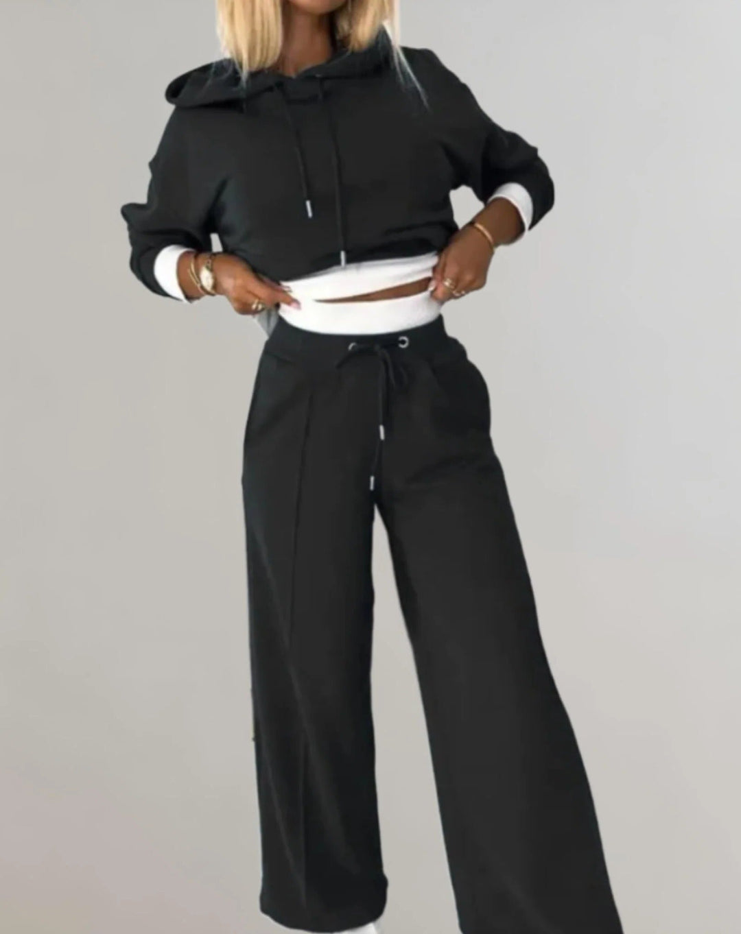 Women's cozy athleisure two-piece hooded sweatsuit in a relaxed fit, perfect for lounging & casual wear.