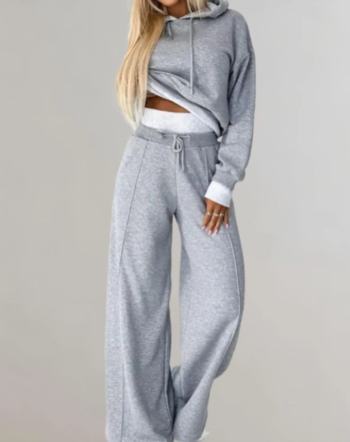 Soft women's hooded sweatshirt & matching sweatpants, a cozy two-piece lounge wear set for comfort.