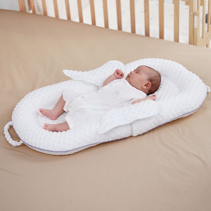 Ergonomic baby sleep nest with breathable mesh, providing back support for newborns & infants 0-12 months.