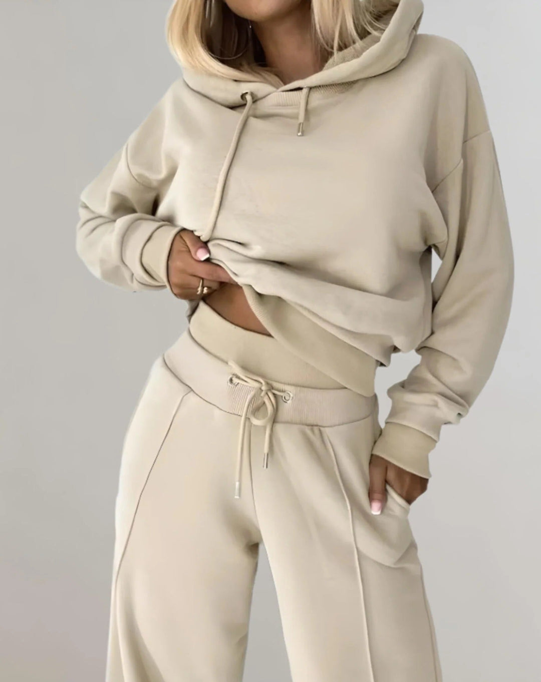 Relaxed fit women's hooded athleisure sweatsuit set, a stylish and comfortable two-piece tracksuit.
