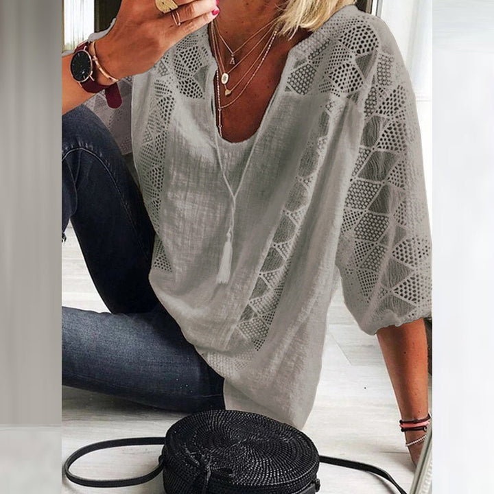 Chic three-quarter sleeve women's blouse with intricate crochet details, ideal for summer and spring outfits.