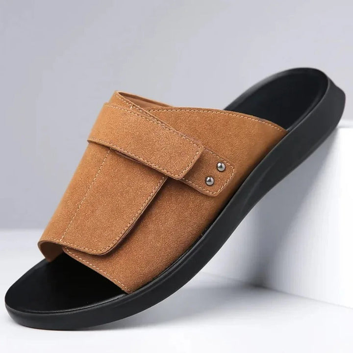 Comfortable men's slip-on slides featuring adjustable strap and molded footbed, perfect for summer beachwear.
