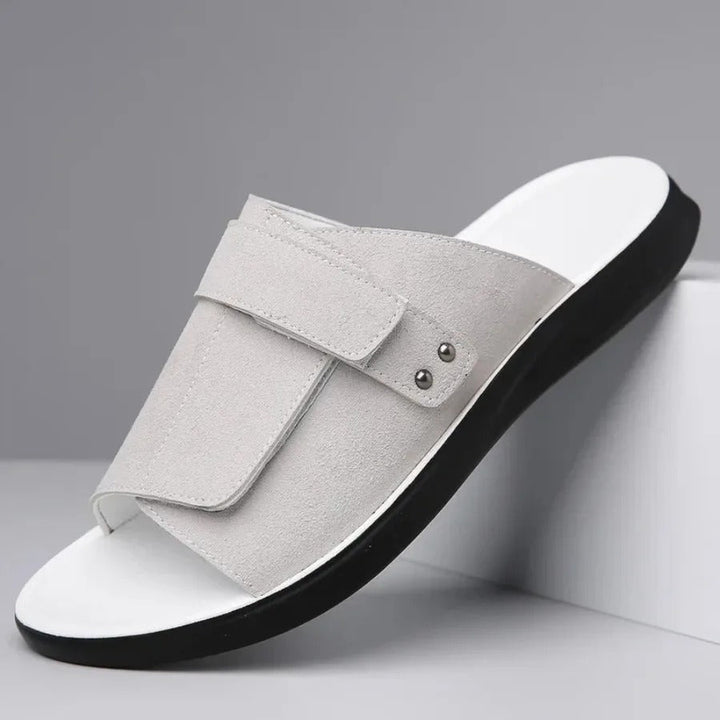 Close-up of men's adjustable strap slides, highlighting the comfortable molded sole for summer casual footwear.