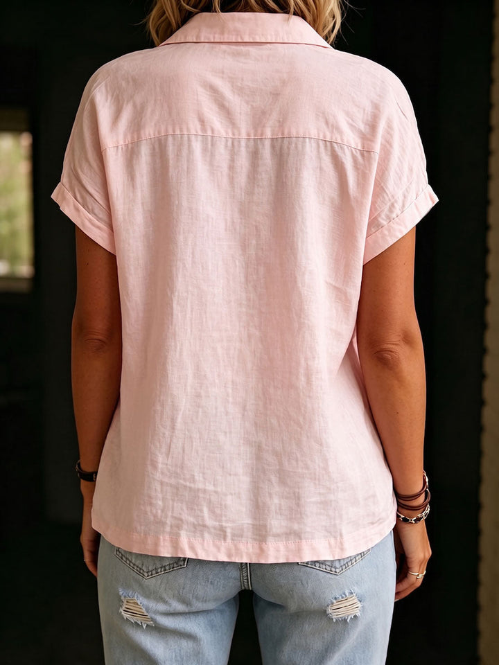Women's versatile pink collared shirt with front pockets & a relaxed, casual fit, ideal for warm weather fashion.