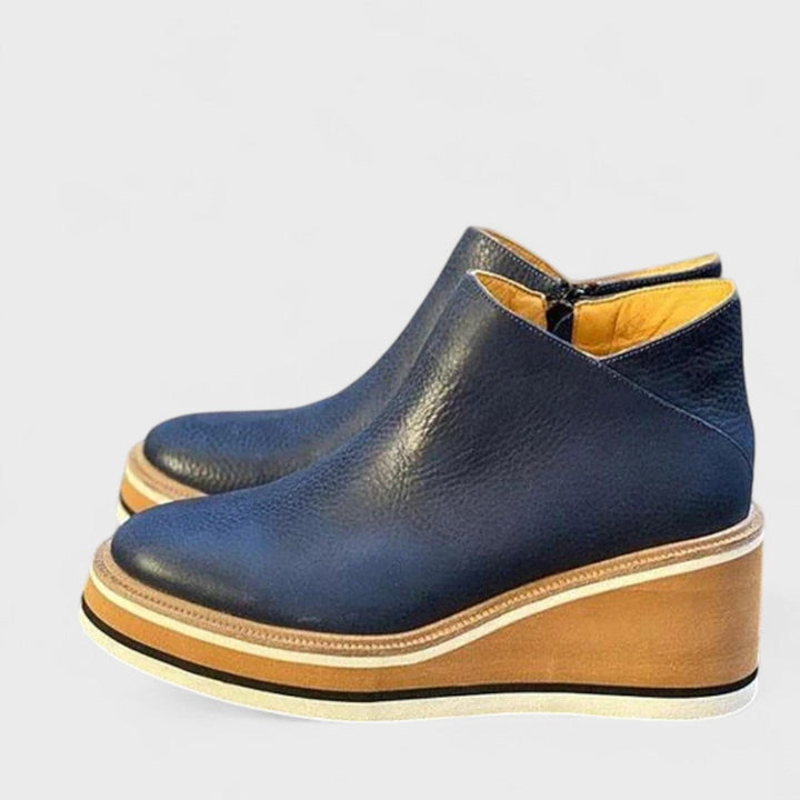 Women's black Chelsea ankle boots with elastic side panels, low heel. Ideal for fall fashion and versatile wear.