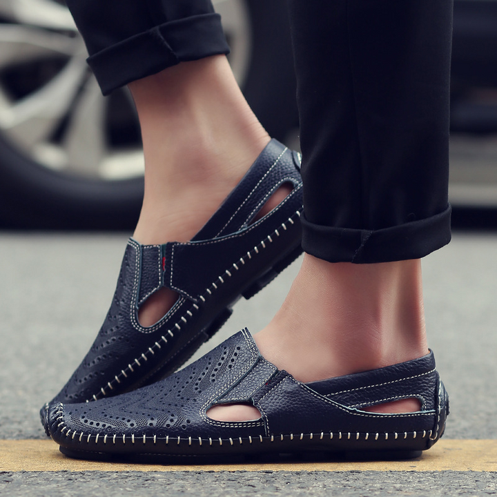Textured men's perforated slides with unique woven stitch detail. Ideal casual summer footwear.