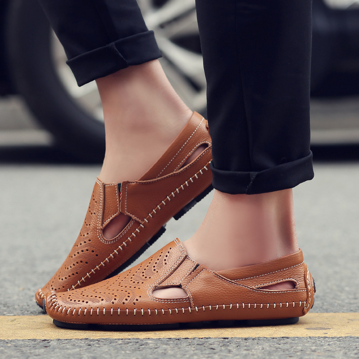 Modern classic men's perforated slides featuring elegant woven stitch. Comfortable casual summer sandals.