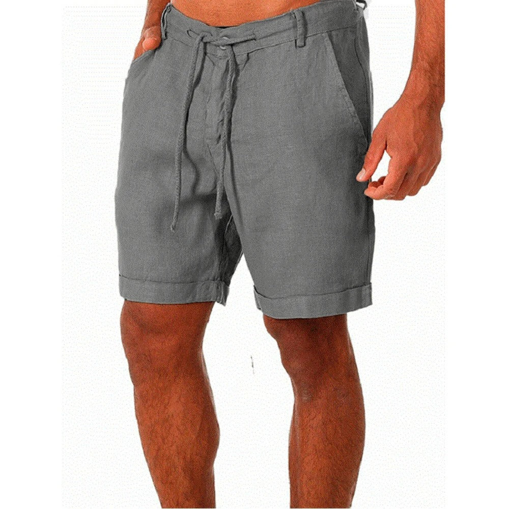 Man wearing light-colored men's relaxed fit drawstring summer shorts for a comfortable, casual warm-weather look.