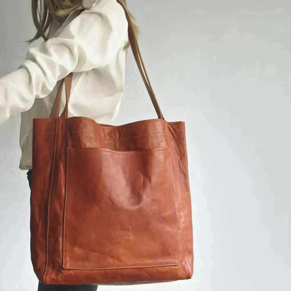 Stylish women's black leather everyday handbag with shoulder strap, perfect for work or casual fashion.