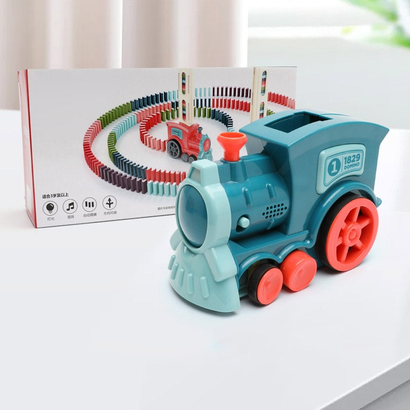 Side view of the automatic domino train laying down a straight line of colorful building blocks.