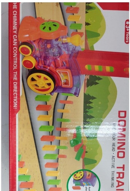 Close-up of the red Automatic Domino Train placing a yellow domino block on the floor.