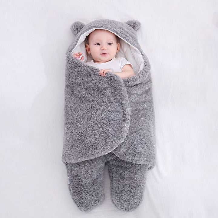 Essential baby sleep sack with legs & hood. Soft sherpa fleece newborn swaddle blanket for cozy infants.