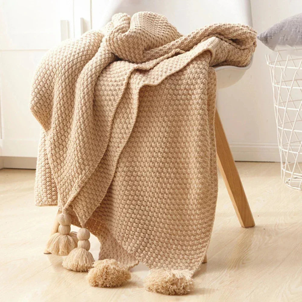 Chic knitted wool throw blanket with tassels, enhancing your home decor with Nordic charm.